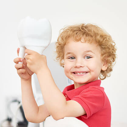 boy with toy tooth