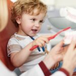 child at dentist for early dental care visit, pediatric dentistry