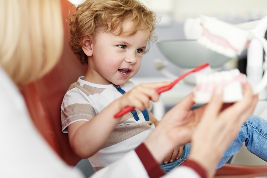 child at dentist for early dental care visit, pediatric dentistry